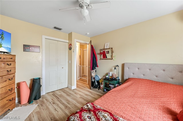 bedroom featuring ceiling fan, a closet, and light wood-type flooring