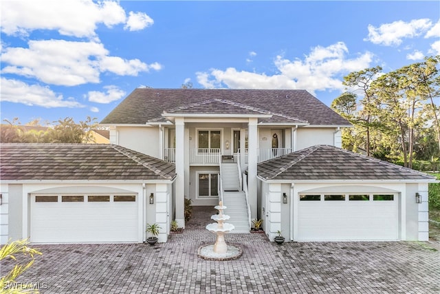 view of front property with a balcony and a garage