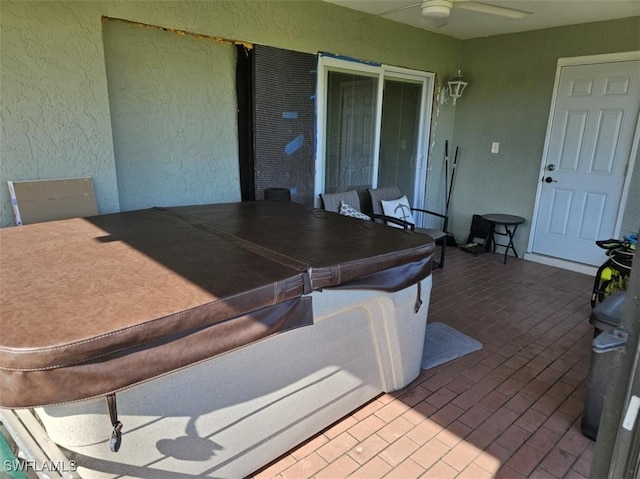 view of patio / terrace featuring a hot tub and ceiling fan