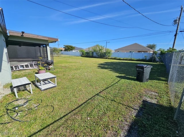 2935 SW 1st Pl, Cape Coral, FL 33914 - view of yard with a fenced backyard and a sunroom