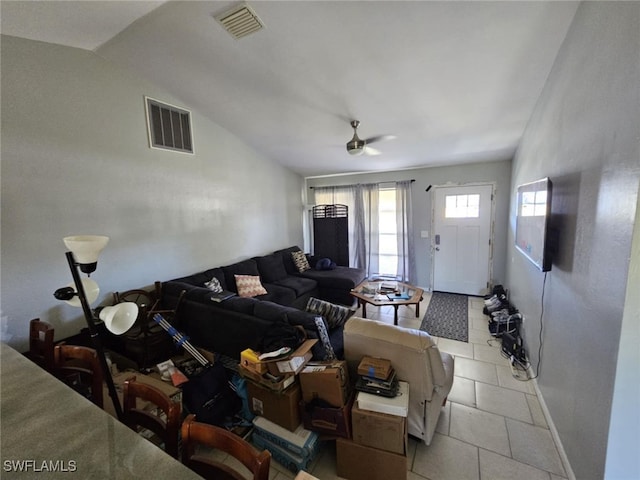 tiled living room with ceiling fan and lofted ceiling