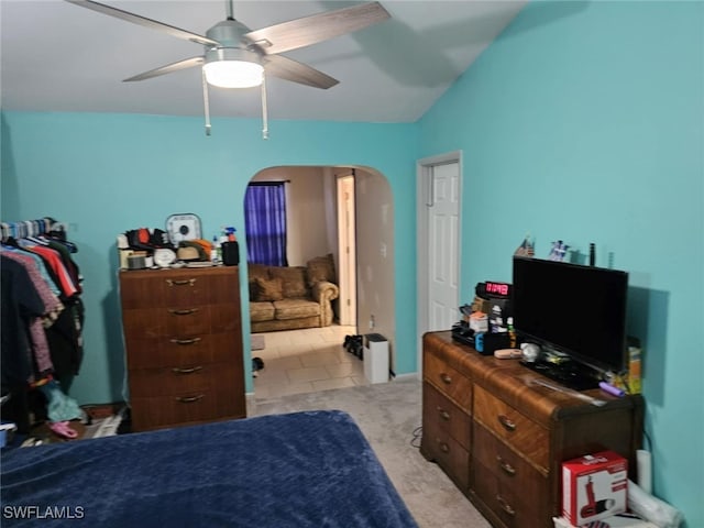 tiled bedroom featuring ceiling fan and lofted ceiling