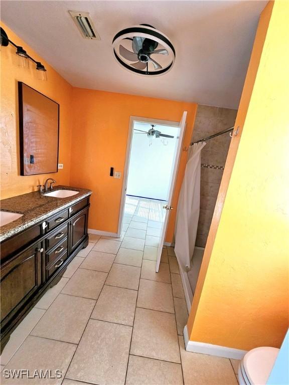 2935 SW 1st Pl, Cape Coral, FL 33914 - bathroom with a shower with shower curtain, tile patterned floors, visible vents, and a sink