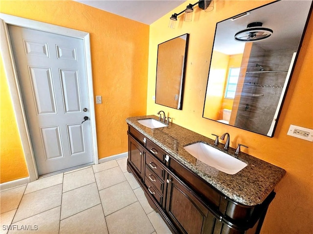 2935 SW 1st Pl, Cape Coral, FL 33914 - full bath featuring a sink, baseboards, double vanity, and tile patterned flooring