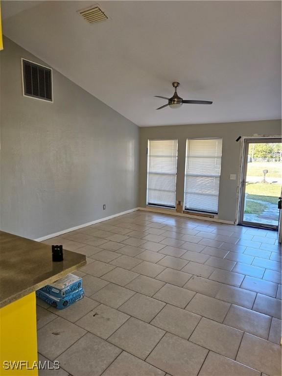 2935 SW 1st Pl, Cape Coral, FL 33914 - unfurnished room with tile patterned floors, visible vents, lofted ceiling, and ceiling fan