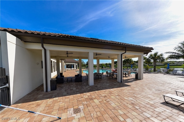 view of patio featuring ceiling fan and a community pool