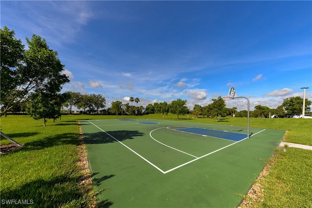 view of sport court featuring a lawn