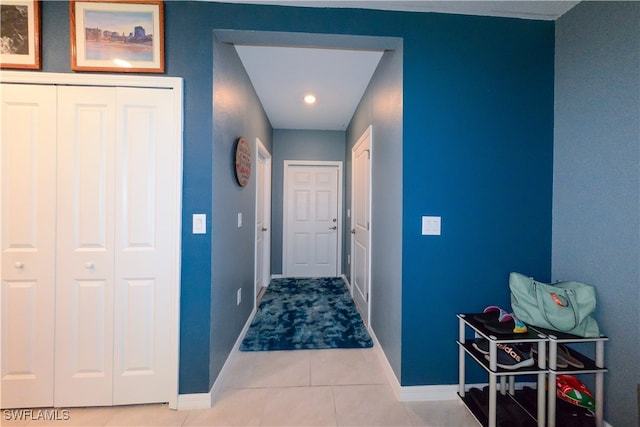 hall featuring light tile patterned floors