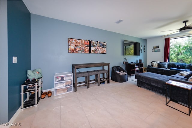 tiled living room featuring ceiling fan