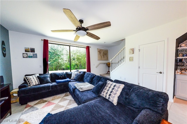 living room with ceiling fan and light tile patterned floors