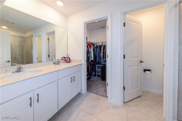 bathroom featuring tile patterned floors, vanity, and walk in shower