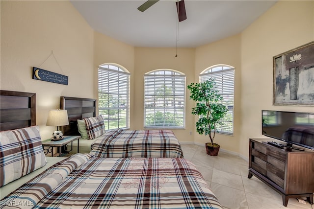 tiled bedroom featuring ceiling fan