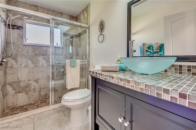 bathroom with vanity, toilet, and walk in shower