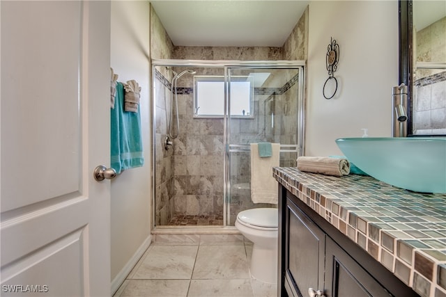 bathroom with vanity, toilet, and a shower with shower door