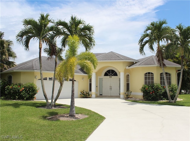 view of front of property featuring a garage and a front lawn