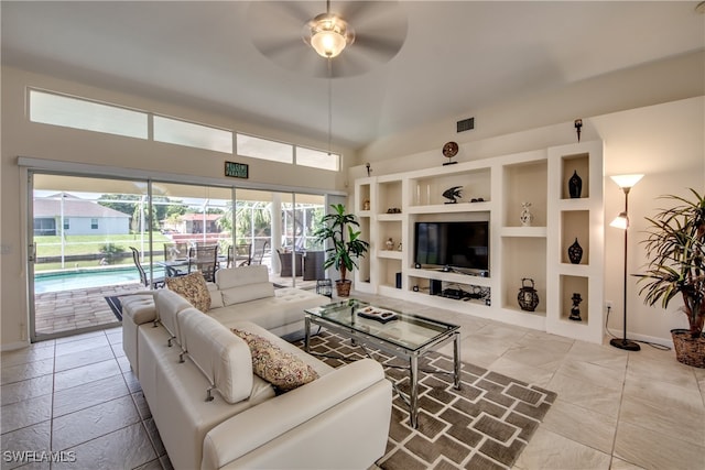 living room featuring built in features and ceiling fan