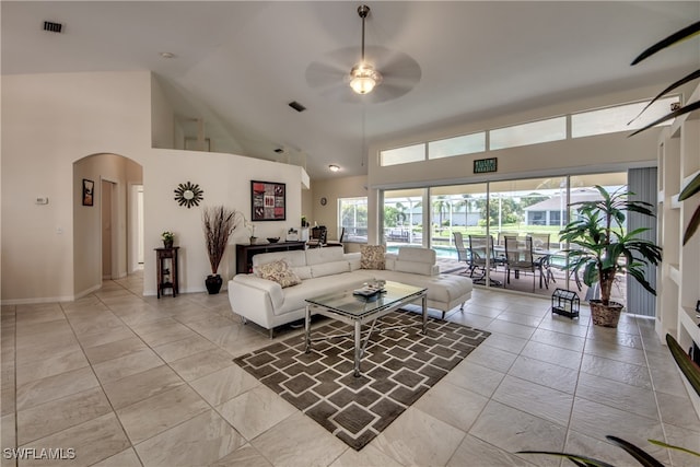 living room with ceiling fan and high vaulted ceiling