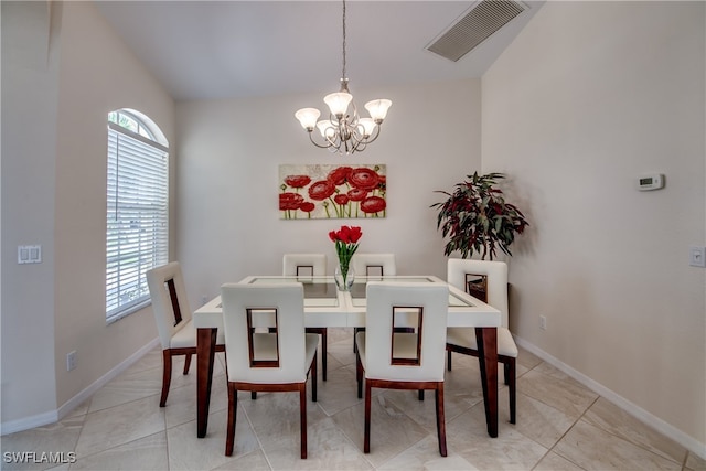 tiled dining area with a notable chandelier