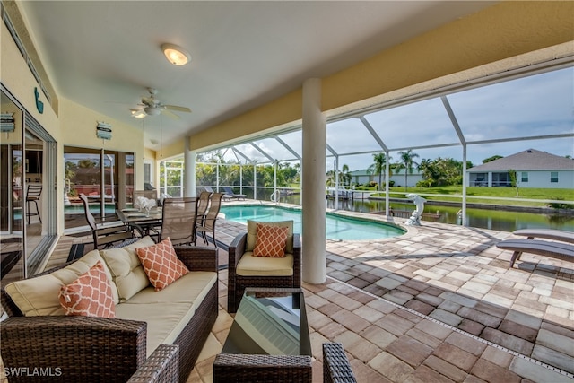 view of swimming pool with outdoor lounge area, a patio area, a lanai, and a water view