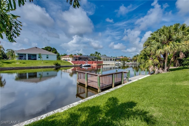 dock area featuring a yard and a water view