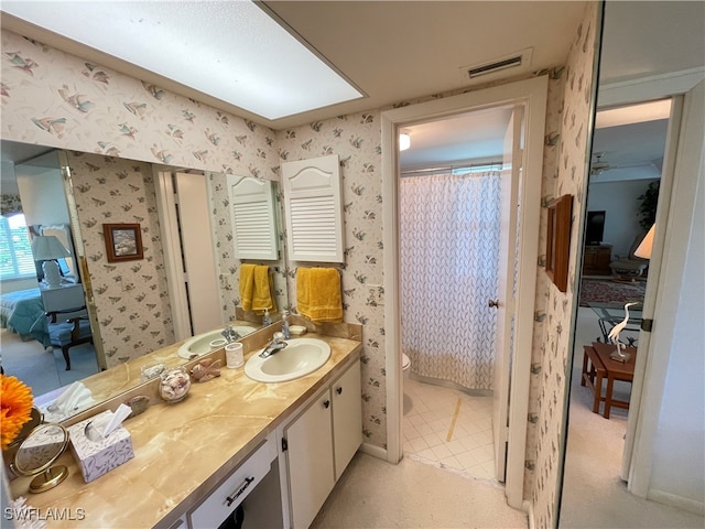 bathroom featuring tile patterned floors, vanity, toilet, and walk in shower