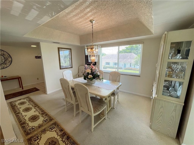 135 Quails Nest Rd Unit 1064, Naples, FL 34112 - dining space with a raised ceiling, light colored carpet, a chandelier, and baseboards