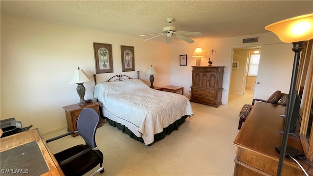 carpeted bedroom with ceiling fan and a textured ceiling