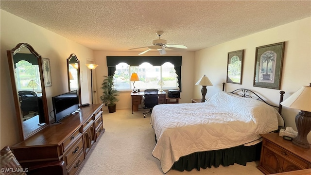 carpeted bedroom with ceiling fan and a textured ceiling