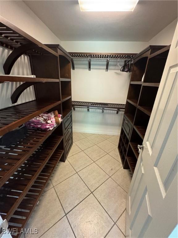 walk in closet featuring tile patterned flooring