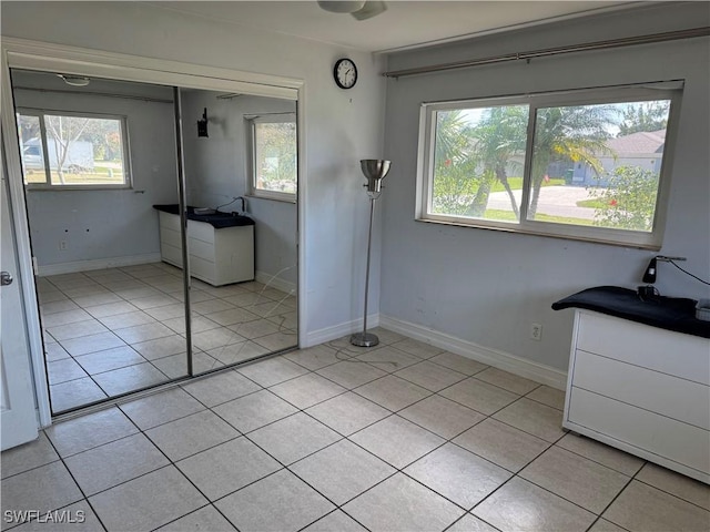 unfurnished bedroom with light tile patterned flooring and multiple windows