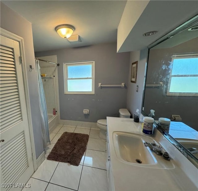 full bathroom featuring a healthy amount of sunlight, toilet, tile patterned flooring, and vanity