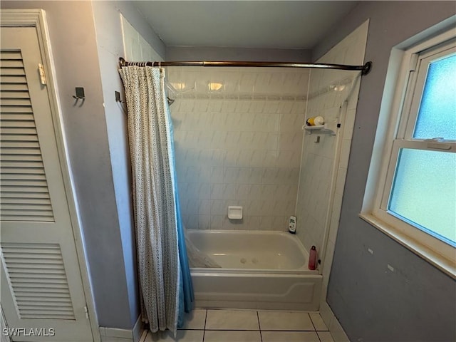 bathroom with tile patterned floors and shower / bath combo