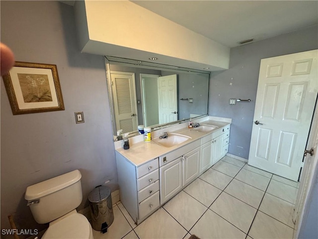 bathroom featuring tile patterned floors, toilet, and vanity