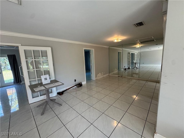 empty room featuring light tile patterned floors and ornamental molding