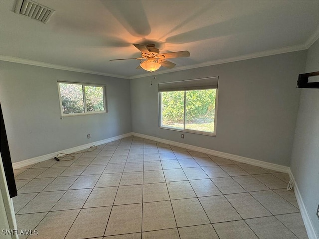 tiled empty room featuring crown molding, ceiling fan, and a healthy amount of sunlight