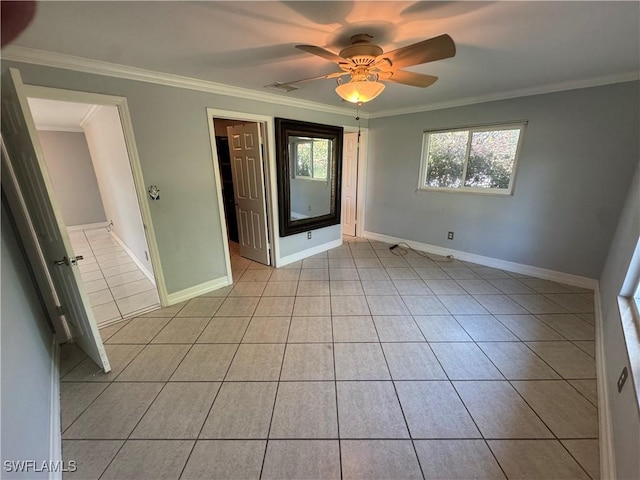 unfurnished room featuring light tile patterned floors, ornamental molding, and ceiling fan