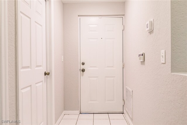 entryway with light tile patterned floors