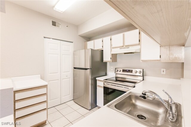 kitchen with sink, white cabinets, light tile patterned floors, and appliances with stainless steel finishes