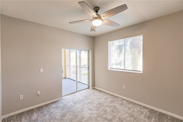 empty room featuring light carpet and ceiling fan