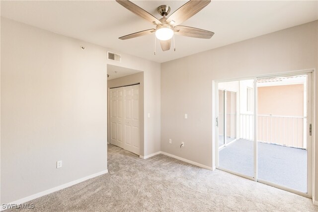 spare room featuring ceiling fan and light carpet