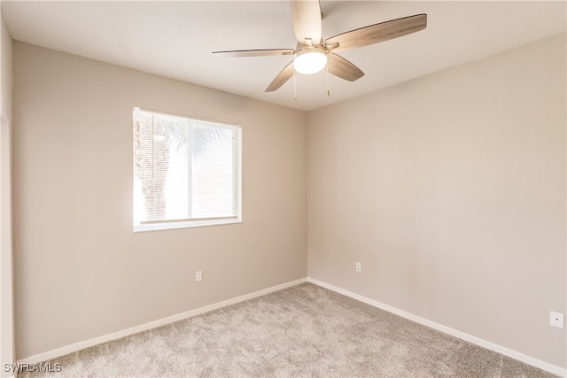 carpeted empty room featuring ceiling fan