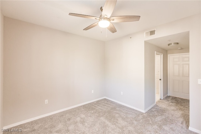 unfurnished room featuring light carpet and ceiling fan