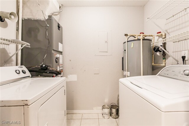 laundry area featuring independent washer and dryer, electric water heater, electric panel, and light tile patterned flooring