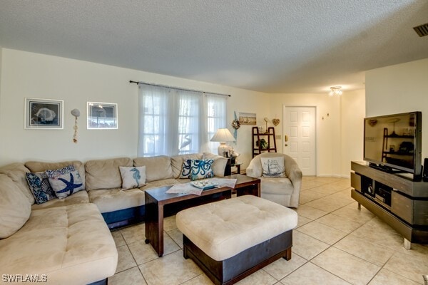 tiled living room featuring a textured ceiling