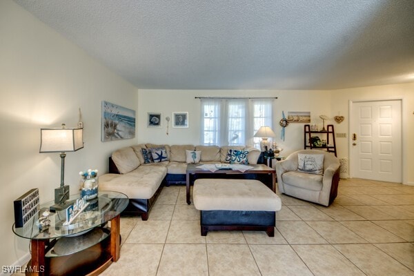 living room with light tile patterned floors and a textured ceiling