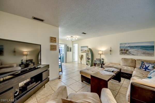 tiled living room with a textured ceiling