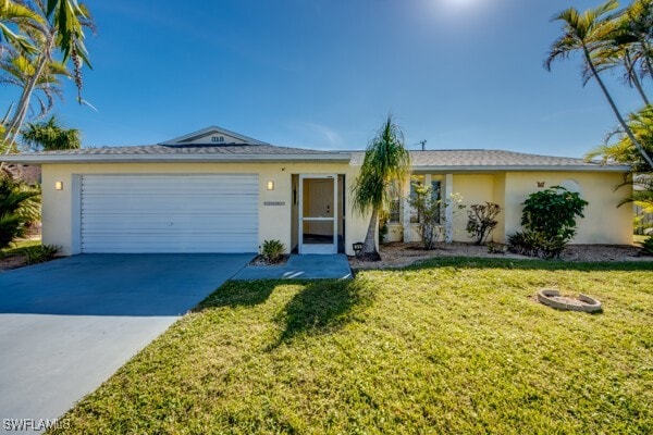 single story home with a front yard and a garage