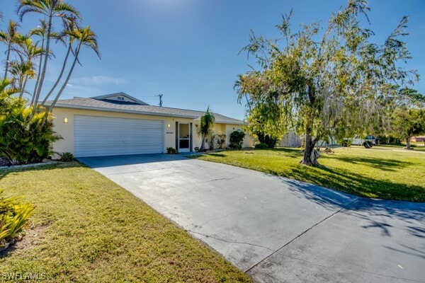 ranch-style home with a garage and a front lawn