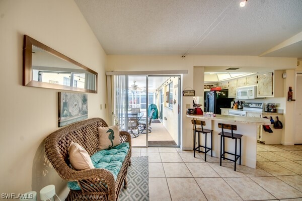 tiled living room featuring a textured ceiling