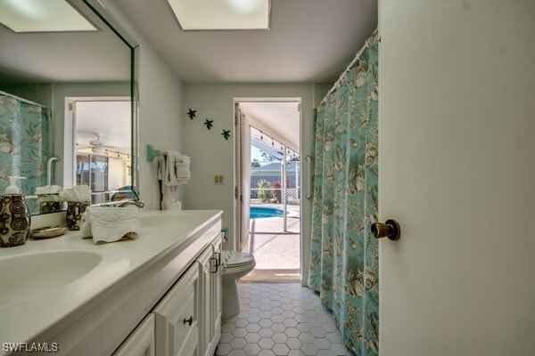 bathroom featuring tile patterned flooring, vanity, and toilet